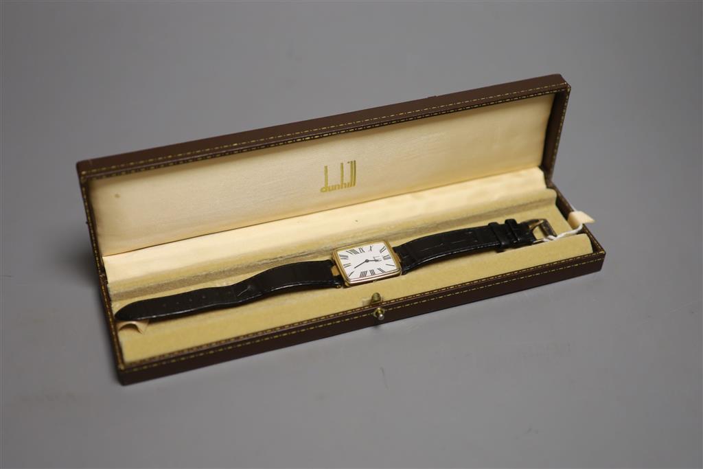 A gentlemans silver gilt Dunhill quartz shaped rectangular dial wrist watch, on a leather strap with Dunhill clasp,